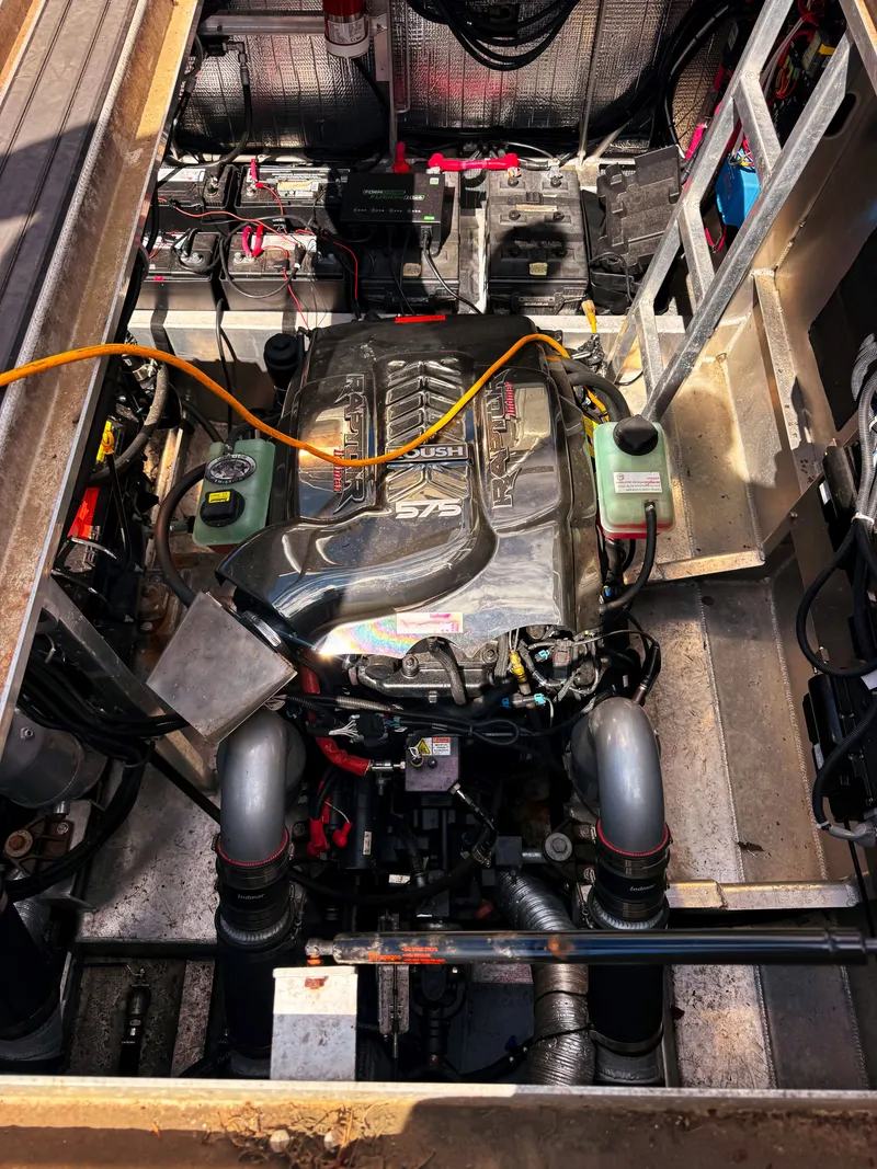 Slide: The Image of Engine compartment of a 2023 Norsco Aluminum Patrol 32 with a powerful engine and wiring. - 7