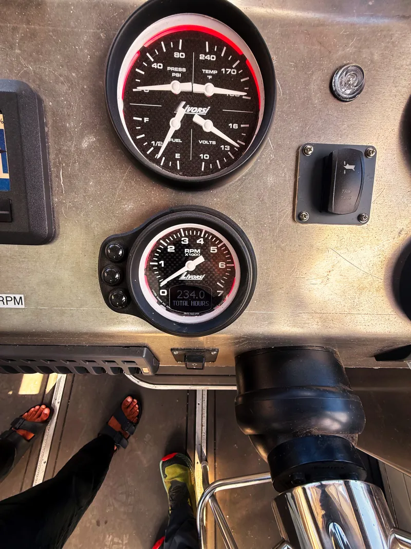 Slide: The Image of Boat dashboard with tachometer and switches. - 12