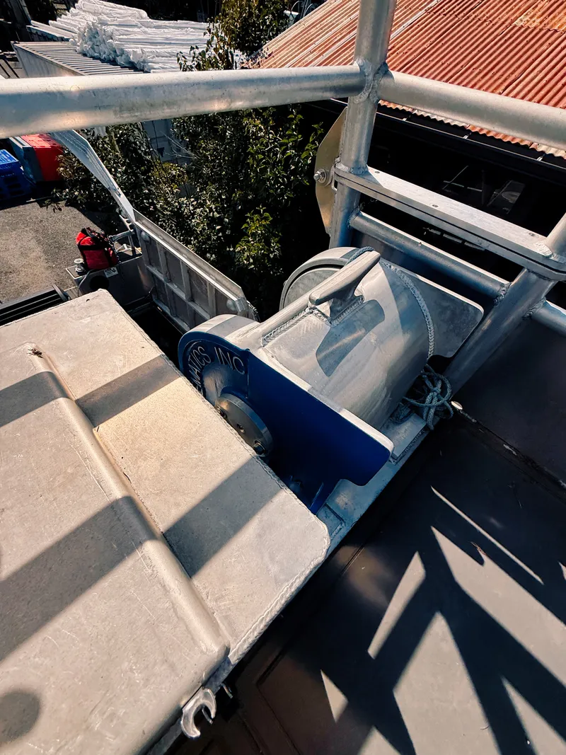 Slide: The Image of An aluminum patrol boat with a sturdy winch mechanism on the deck. - 23