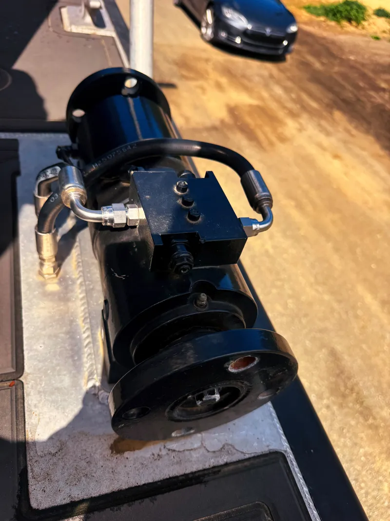 Slide: The Image of Hydraulic pump on a boat with a road in the background. - 14