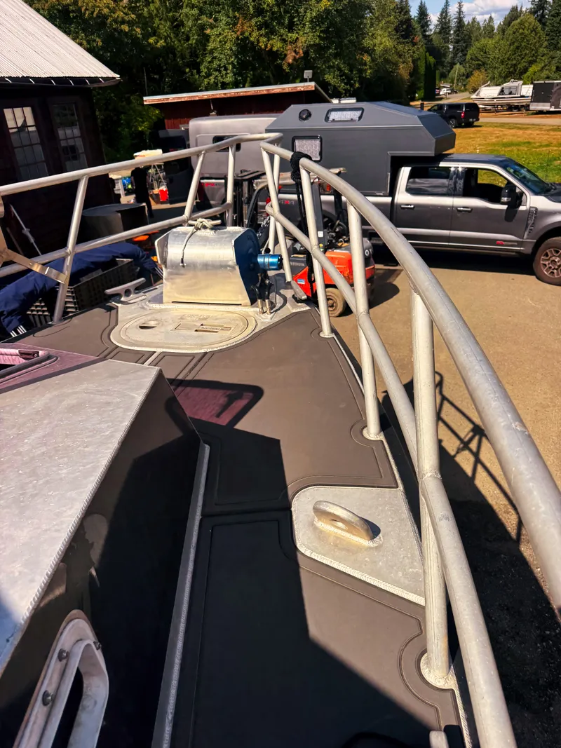 Slide: The Image of The image shows the deck of a Norsco Aluminum Patrol 32 boat with sturdy railings. - 19