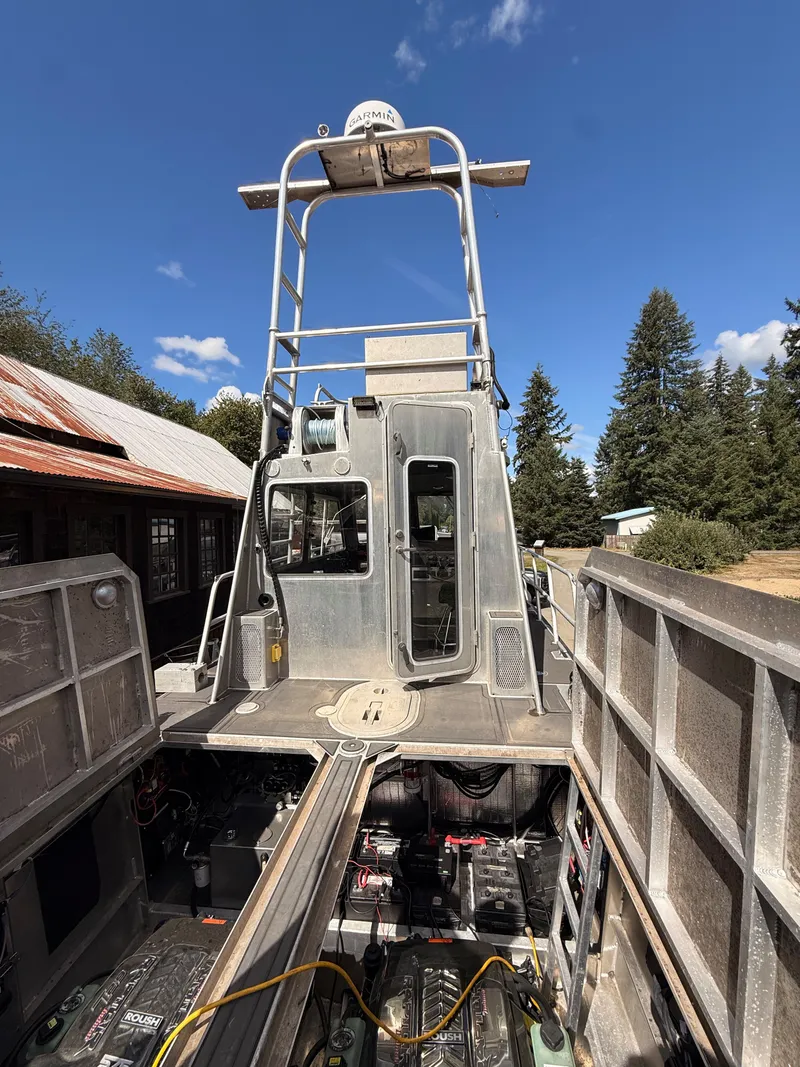 Slide: The Image of The image shows a sturdy aluminum patrol boat with an elevated helm and technical equipment. - 2
