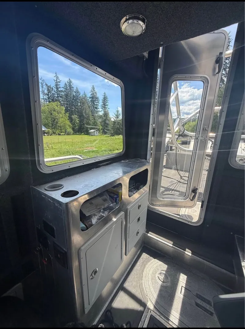 Slide: The Image of Interior of a modern boat with aluminum surfaces and large windows showing a green landscape. - 3