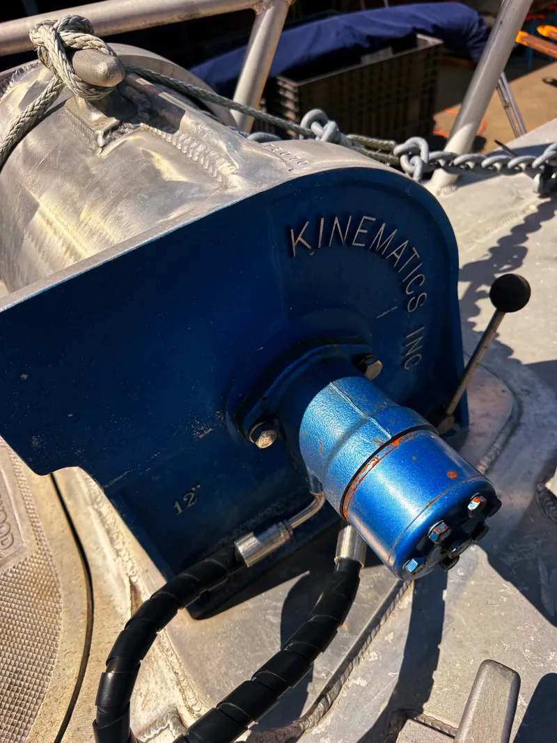 Slide: The Image of Close-up of a blue winch on an aluminum boat with chains and ropes. - 20