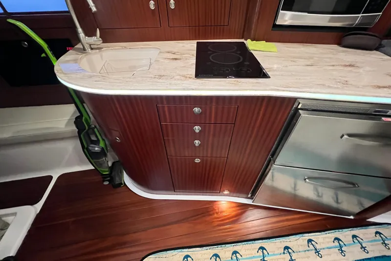 Slide: The Image of Luxurious 2018 Pursuit OS 385 Offshore yacht kitchen with modern appliances and elegant wood finish. - 8