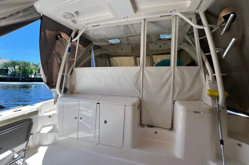 Slide: The Image of 2018 Pursuit OS 385 Offshore boat interior with storage compartments and ladder. - 23