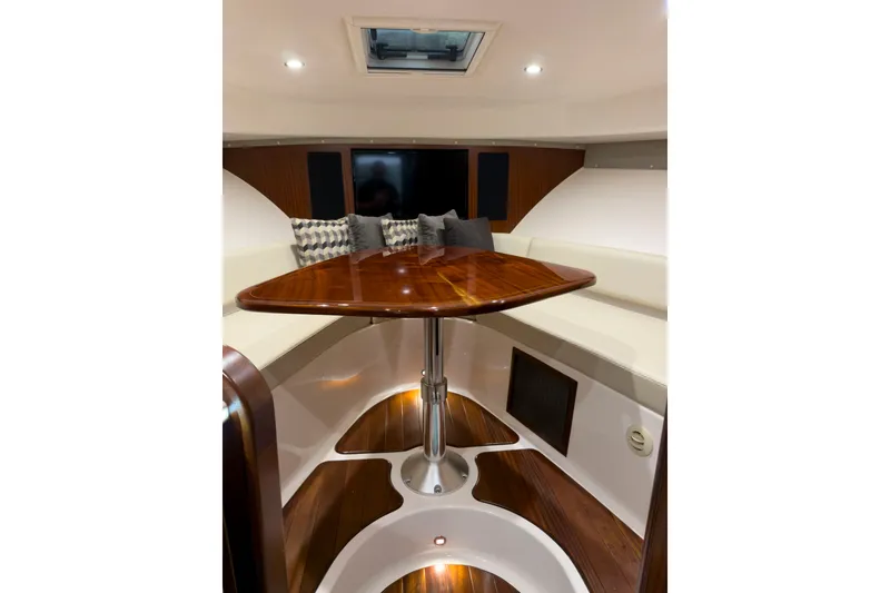 Slide: The Image of Luxurious interior of 2018 Pursuit OS 385 Offshore boat with elegant wood table. - 14