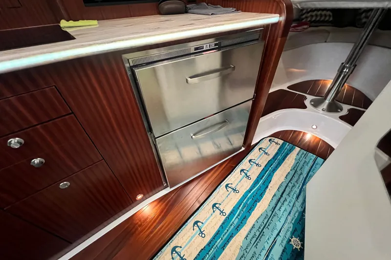 Slide: The Image of Luxurious 2018 Pursuit OS 385 Offshore yacht interior with wood cabinetry and stainless steel appliances. - 15
