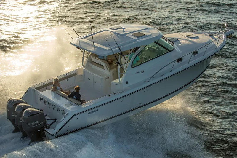Slide: The Image of Manufacturer Provided Image: 2018 Pursuit OS 385 Offshore boat cruising on the water at sunset. - 39