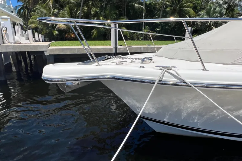 Slide: The Image of 2018 Pursuit OS 385 Offshore boat docked, featuring sleek design and stainless steel railings. - 5