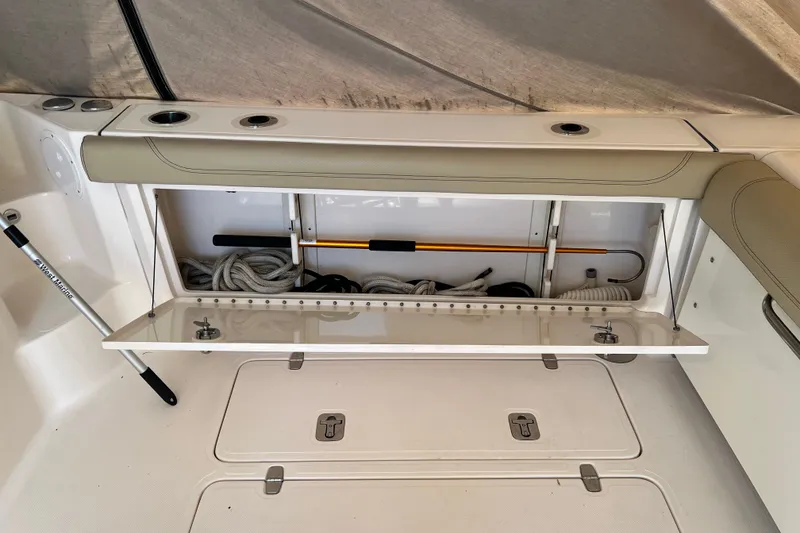 Slide: The Image of 2018 Pursuit OS 385 Offshore boat storage compartment with ropes and equipment. - 37