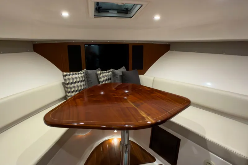 Slide: The Image of Luxurious interior of 2018 Pursuit OS 385 Offshore boat with elegant wood table. - 15