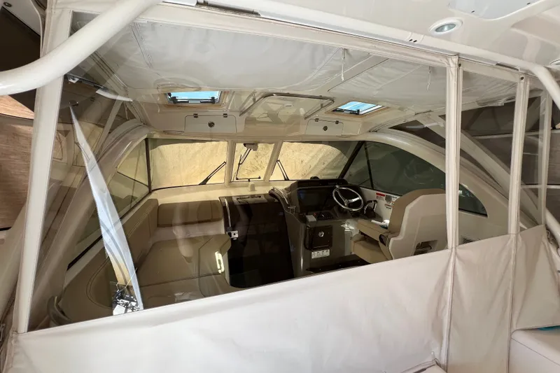 Slide: The Image of 2018 Pursuit OS 385 Offshore boat interior with helm and seating area. - 24