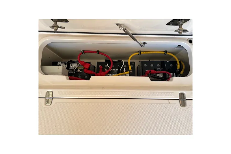 Slide: The Image of Battery compartment of 2018 Pursuit OS 385 Offshore boat with red and yellow cables. - 38