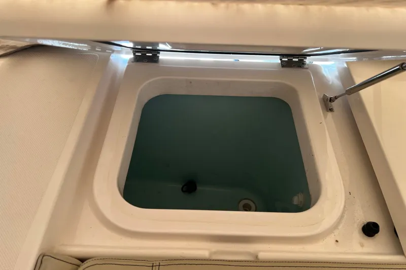 Slide: The Image of Open storage compartment on 2018 Pursuit OS 385 Offshore boat. - 32