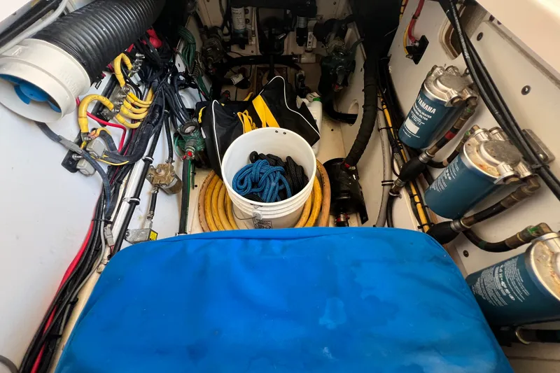 Slide: The Image of 2018 Pursuit OS 385 Offshore engine room with cables, filters, and equipment. - 31