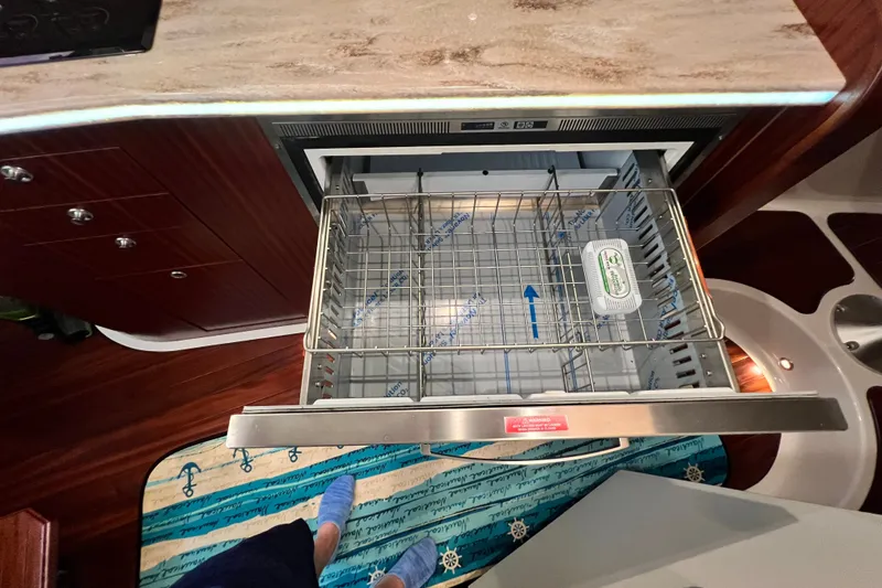 Slide: The Image of Open drawer in 2018 Pursuit OS 385 Offshore boat kitchen, showing interior storage space. - 10