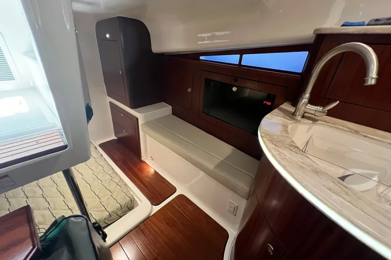 Slide: The Image of Luxurious interior of 2018 Pursuit OS 385 Offshore boat with wood accents and modern amenities. - 12