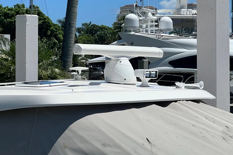 Slide: The Image of 2018 Pursuit OS 385 Offshore boat docked, featuring radar and navigation equipment. - 6