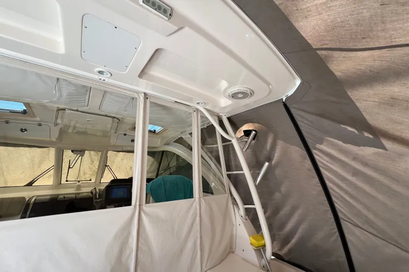 Slide: The Image of 2018 Pursuit OS 385 Offshore boat interior with helm and seating area. - 26