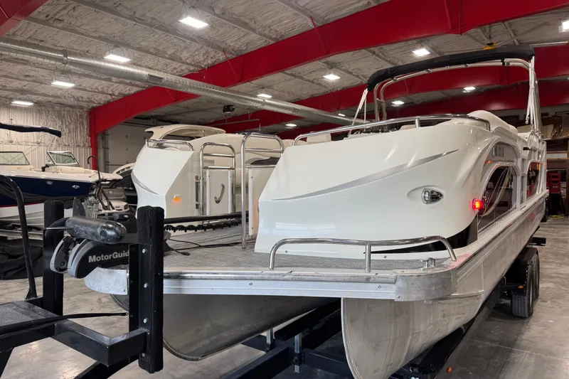 Slide: The Image of 2014 JC 26 SportToon pontoon boat in a spacious indoor storage facility. - 14