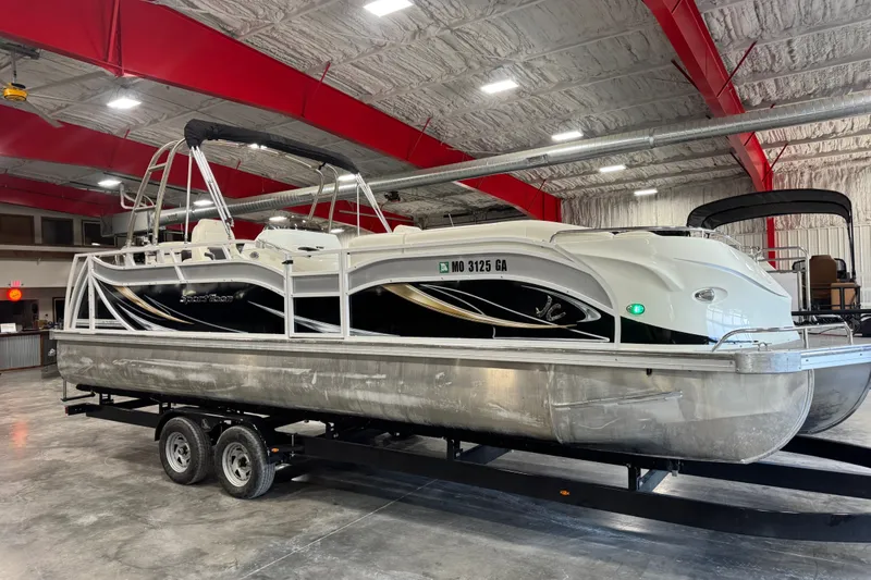 The Image of 2014 JC 26 SportToon pontoon boat on trailer in indoor storage facility. - 1