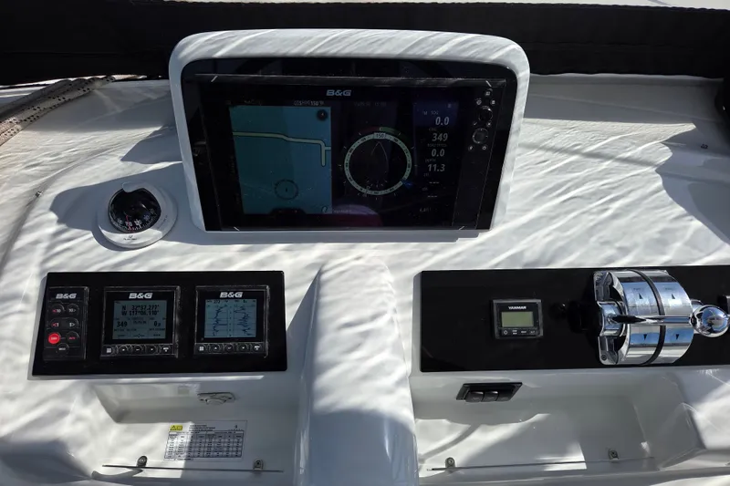 Slide: The Image of Control panel of a 2022 Lagoon 46 yacht with navigation instruments and throttle controls. - 15