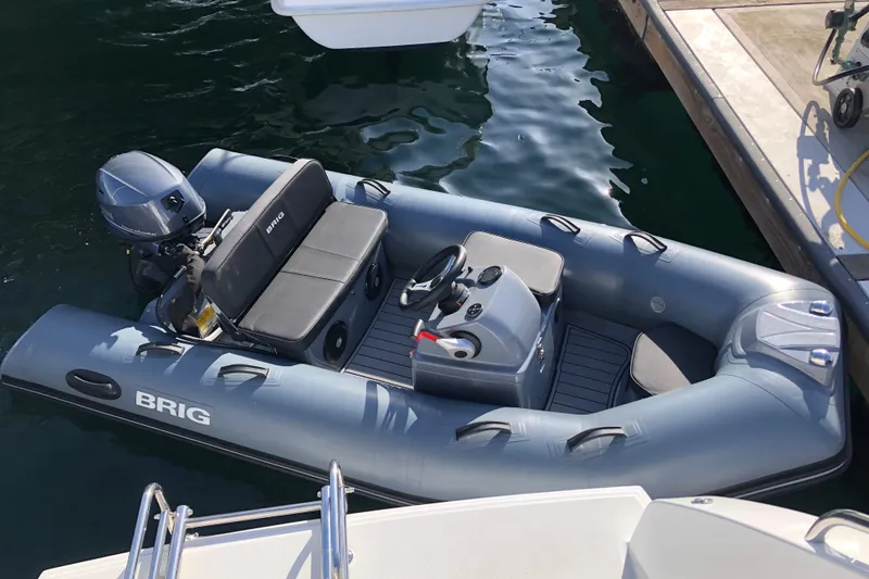 Slide: The Image of Inflatable Brig boat docked beside a 2022 Lagoon 46 yacht. - 46