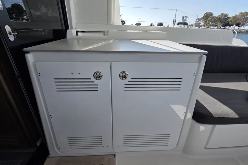 Slide: The Image of White storage cabinet on Lagoon 46 yacht, 2022 model, with seating area. - 13