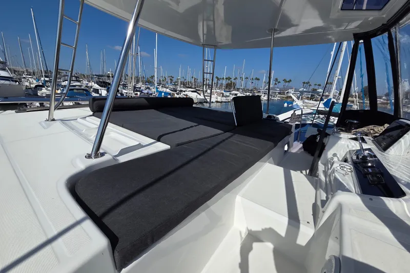 Slide: The Image of Luxurious Lagoon 46 catamaran deck, 2022 model, docked in a sunny marina. - 19