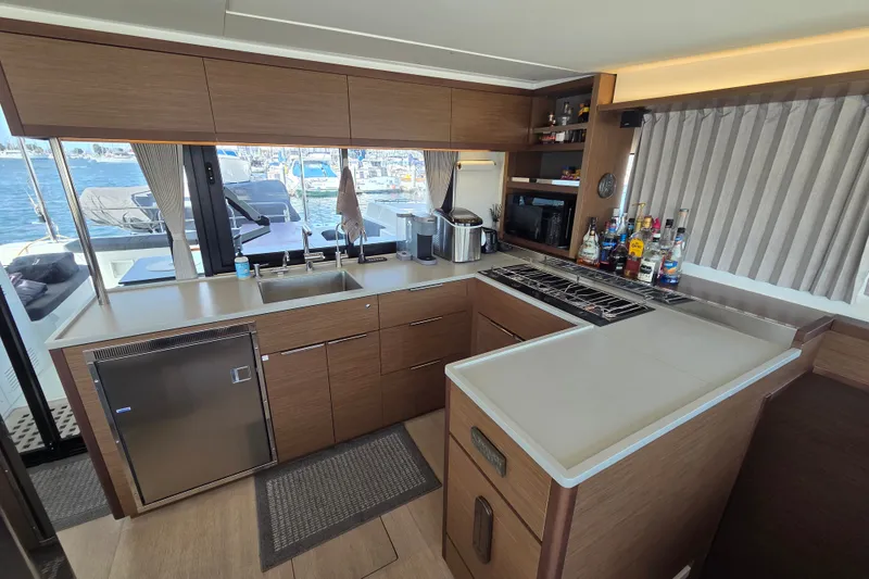 Slide: The Image of Modern kitchen interior on 2022 Lagoon 46 yacht with appliances and ocean view. - 25