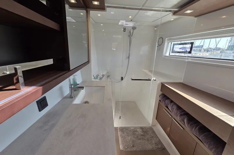 Slide: The Image of Modern bathroom interior on 2022 Lagoon 46 yacht, featuring sleek design and ample natural light. - 38