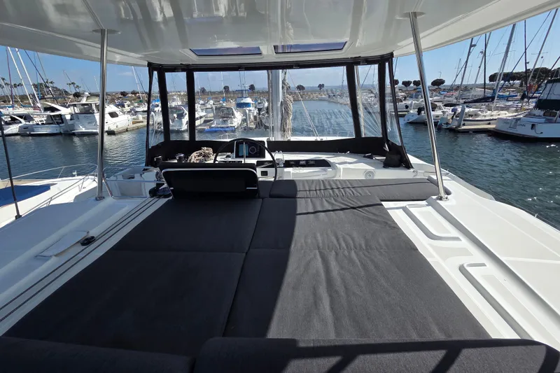 Slide: The Image of Luxurious 2022 Lagoon 46 catamaran with spacious deck, docked at marina. - 18