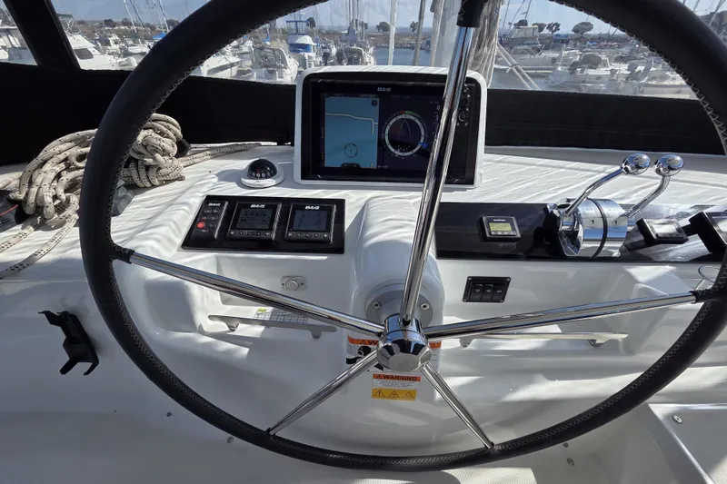 Slide: The Image of Steering wheel and controls of a 2022 Lagoon 46 catamaran yacht. - 17