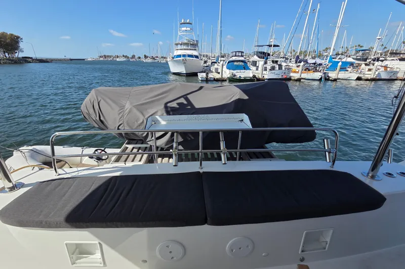 Slide: The Image of Lagoon 46 catamaran, 2022 model, docked at marina with covered seating area. - 14
