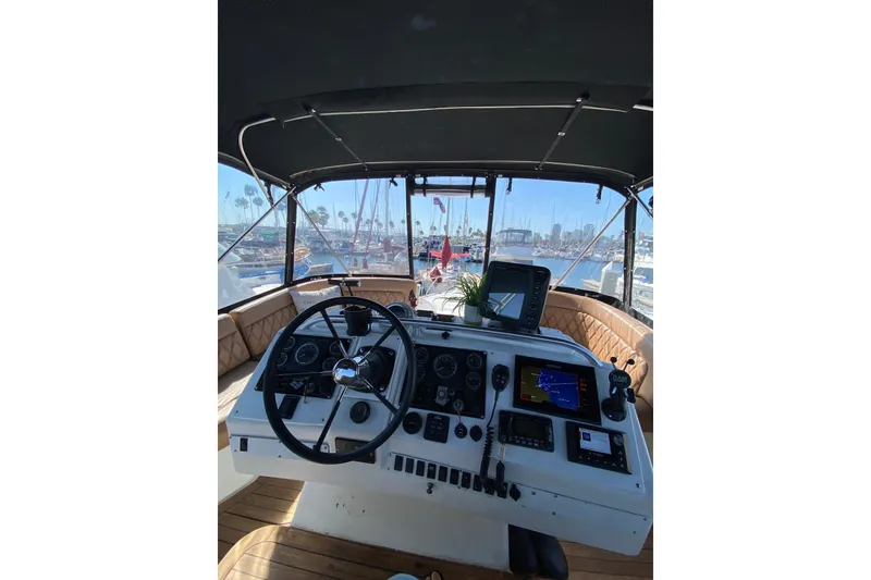 Slide: The Image of 1997 Mainship 40 Sedan Bridge helm with navigation equipment and marina view. - 19