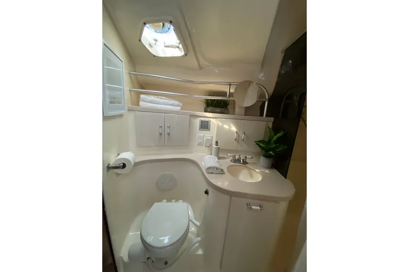 Slide: The Image of Luxurious bathroom in 1997 Mainship 40 Sedan Bridge yacht, featuring modern fixtures and elegant design. - 15