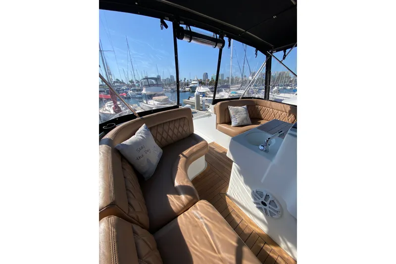 Slide: The Image of Luxurious interior of 1997 Mainship 40 Sedan Bridge yacht with marina view. - 20