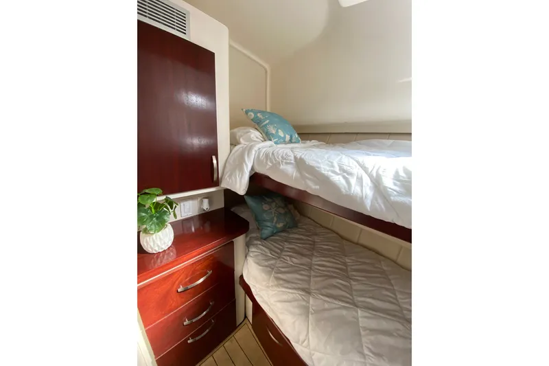 Slide: The Image of 1997 Mainship 40 Sedan Bridge cabin with bunk beds and wooden cabinetry. - 14
