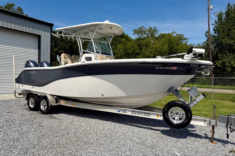 The Image of 2017 Sea Fox 266 Commander boat on trailer, parked outside a garage. - 1