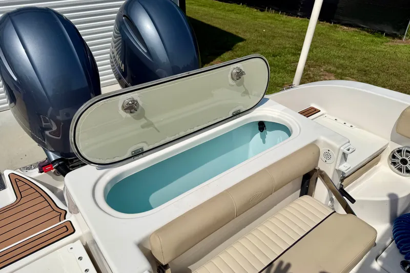 Slide: The Image of 2017 Sea Fox 266 Commander boat with open livewell and dual outboard engines. - 22