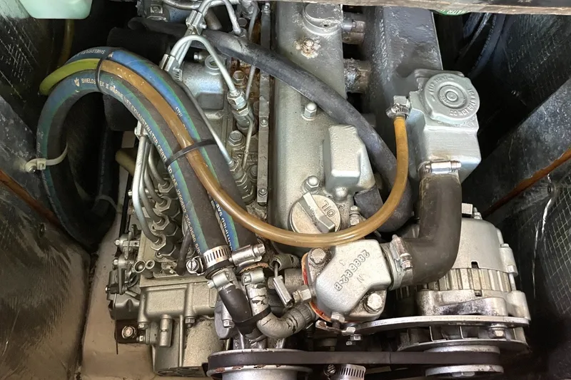 Slide: The Image of Catalina 350 2004 engine compartment with visible hoses and mechanical components. - 11