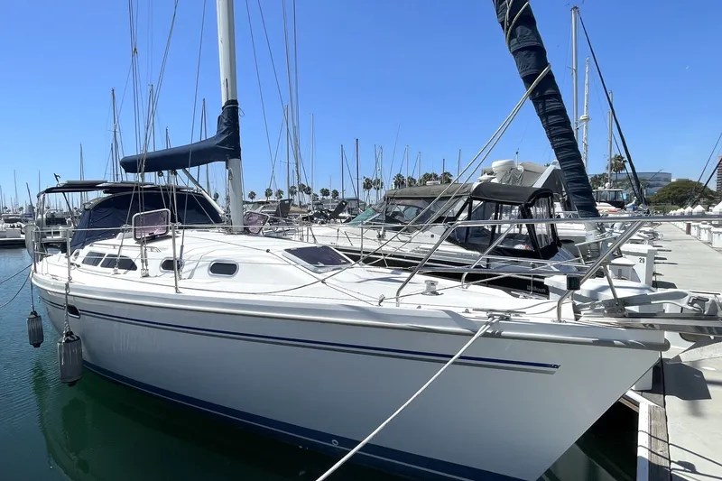 The Image of 2004 Catalina 350 sailboat docked at marina under clear blue sky. - 0