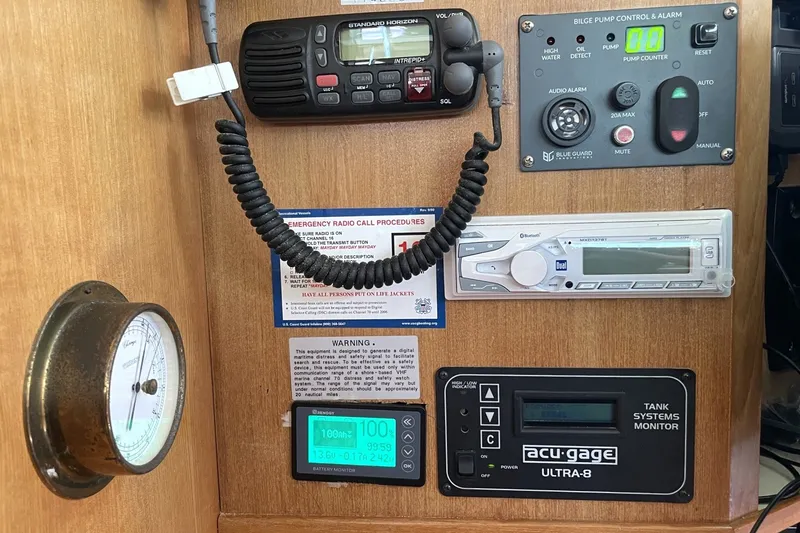 Slide: The Image of Control panel of a 2004 Catalina 350 yacht with radio, gauges, and alarm systems. - 9