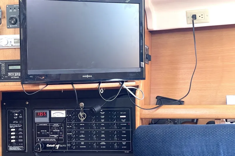 Slide: The Image of Control panel and TV setup inside a 2004 Catalina 350 yacht cabin. - 8