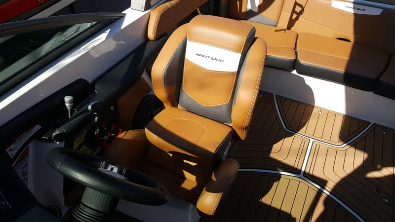 Slide: The Image of The image shows the interior of a 2017 Nautique Super Air Nautique 210 with brown leather seats. - 5