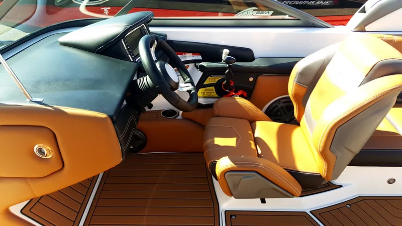 Slide: The Image of The image shows the cockpit of a 2017 Nautique Super Air Nautique 210 with brown leather seats. - 4