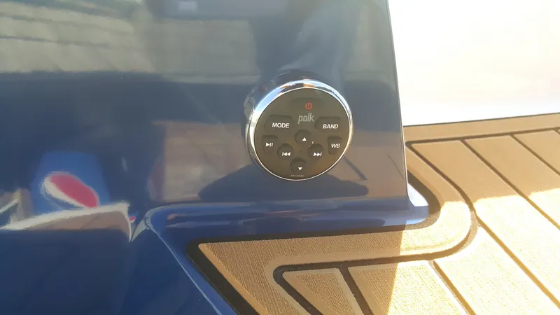 Slide: The Image of Close-up of a Polk audio control panel on a boat with blue trim and wooden flooring. - 19