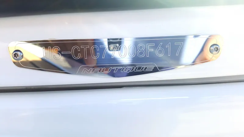Slide: The Image of Metal plaque with serial number and Nautique logo on a boat. - 21