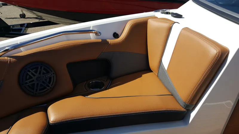 Slide: The Image of The image shows a brown and black leather seat in a boat with a speaker and cup holder. - 17